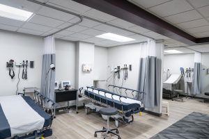 Two hospital exam bays with two hospital beds